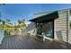 Inviting balcony with seating offering serene views of surrounding trees and tropical greenery at 3446 Anglin Dr, Sarasota, FL 34242