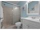 Clean bathroom featuring a tiled shower with glass door, white vanity, and a toilet at 3446 Anglin Dr, Sarasota, FL 34242