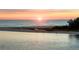 Scenic beach view with the sun setting over the ocean, a sandy beach, and the tranquil waters at 3446 Anglin Dr, Sarasota, FL 34242