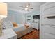 This comfortable bedroom features a ceiling fan, hardwood floors, and a large closet at 3446 Anglin Dr, Sarasota, FL 34242