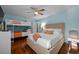 This comfortable bedroom features a ceiling fan, hardwood floors, and a large closet at 3446 Anglin Dr, Sarasota, FL 34242