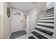 Entryway with white door, tiled floor, and carpeted staircase at 3446 Anglin Dr, Sarasota, FL 34242