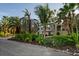 Home exterior showcasing manicured landscaping, mature palm trees, and a well-maintained facade at 3446 Anglin Dr, Sarasota, FL 34242