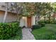 Inviting front entrance featuring a brick path, vibrant foliage, and a well-maintained lawn at 3446 Anglin Dr, Sarasota, FL 34242
