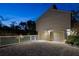 Two-car garage with a wide paver driveway, complemented by manicured landscaping and evening lighting at 3446 Anglin Dr, Sarasota, FL 34242
