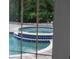 Close-up of a jacuzzi with blue tile trim next to a pool and a privacy fence at 3446 Anglin Dr, Sarasota, FL 34242