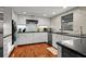 Modern kitchen features white cabinetry, granite countertops, and updated appliances at 3446 Anglin Dr, Sarasota, FL 34242