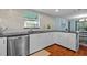 Updated kitchen features stainless steel appliances, white cabinetry, and tile backsplash at 3446 Anglin Dr, Sarasota, FL 34242