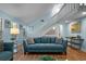 Relaxing living room with blue sofa, lots of natural light, and staircase to second floor at 3446 Anglin Dr, Sarasota, FL 34242