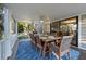 Relax on this screened patio with ceiling fan and dining area overlooking mature landscaping at 3446 Anglin Dr, Sarasota, FL 34242