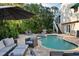 Beautiful backyard pool and spa with outdoor seating and lounge chairs, all surrounded by lush tropical landscaping at 3446 Anglin Dr, Sarasota, FL 34242