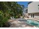 Backyard pool and spa, with nearby grill and patio lead to a second story screened porch at 3446 Anglin Dr, Sarasota, FL 34242
