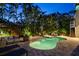 Backyard pool and spa with outdoor seating area, lush landscaping, and exterior stairs at 3446 Anglin Dr, Sarasota, FL 34242