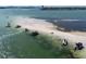 Aerial shot of a sandbar with people and boats enjoying the day on the beautiful water at 3446 Anglin Dr, Sarasota, FL 34242