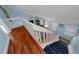 Bright home staircase with hardwood treads, blue carpet, and view of the lovely living room at 3446 Anglin Dr, Sarasota, FL 34242