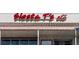Storefront with a red sign and tile roof, offering retail space in a commercial area at 3446 Anglin Dr, Sarasota, FL 34242