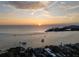 Breathtaking sunset view with boats on the water and houses along the shoreline at 3446 Anglin Dr, Sarasota, FL 34242