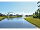 Scenic backyard view featuring a tranquil pond with fountain and well-maintained lawn at 364 Grande Vista Blvd, Bradenton, FL 34212