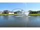 Scenic backyard view featuring a tranquil pond with fountain and well-maintained lawn at 364 Grande Vista Blvd, Bradenton, FL 34212