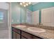 Bathroom featuring granite counters, double sinks, and stylish fixtures at 364 Grande Vista Blvd, Bradenton, FL 34212