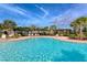 Stunning community pool featuring lounge chairs and shaded pergola areas, perfect for relaxing and enjoying the Florida sunshine at 364 Grande Vista Blvd, Bradenton, FL 34212