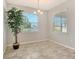 A bright dining area is enhanced by sunlight, neutral tones and a decorative tree at 364 Grande Vista Blvd, Bradenton, FL 34212