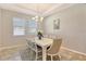 Bright dining room with neutral paint, large windows, and a stylish chandelier above a white table at 364 Grande Vista Blvd, Bradenton, FL 34212