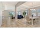 Open-concept dining and living area with tile floors, neutral walls, and ample natural light at 364 Grande Vista Blvd, Bradenton, FL 34212
