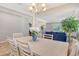 Open dining area flows into the living space, featuring tile floors and natural light from large windows at 364 Grande Vista Blvd, Bradenton, FL 34212