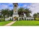 Grand community entrance with a bell tower, lush landscaping, and 'Del Tierra' signage at 364 Grande Vista Blvd, Bradenton, FL 34212