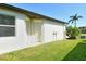Exterior side view of home with green grass and bright blue sky at 364 Grande Vista Blvd, Bradenton, FL 34212
