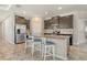 A spacious kitchen with stainless steel appliances, a granite island, and stylish white seating at 364 Grande Vista Blvd, Bradenton, FL 34212