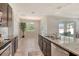 Kitchen features a granite counter island, stainless steel appliances, and opens to the dining area and backyard view at 364 Grande Vista Blvd, Bradenton, FL 34212