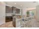 Kitchen with an island featuring seating, granite countertops, dark wood cabinets, and stainless steel appliances at 364 Grande Vista Blvd, Bradenton, FL 34212