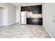 A kitchenette area features dark cabinets, stainless steel appliances and tiled floors at 364 Grande Vista Blvd, Bradenton, FL 34212