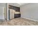 A kitchenette area features dark cabinets, stainless steel appliances and tiled floors at 364 Grande Vista Blvd, Bradenton, FL 34212