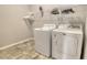 Functional laundry room with a washer, dryer, and shelving at 364 Grande Vista Blvd, Bradenton, FL 34212