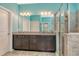 Main bathroom with dual vanities, granite counters, framed mirror and walk-in shower at 364 Grande Vista Blvd, Bradenton, FL 34212