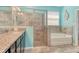 Bathroom showcases a soaking tub, a walk-in shower, granite counters and dual-sink vanity at 364 Grande Vista Blvd, Bradenton, FL 34212