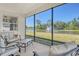 Relaxing screened patio view overlooking the serene pond with a fountain feature and comfortable patio furniture at 364 Grande Vista Blvd, Bradenton, FL 34212