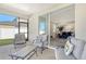 Outdoor patio with comfortable seating offering a glimpse into the stylishly furnished living area at 364 Grande Vista Blvd, Bradenton, FL 34212