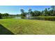 Scenic view of a serene pond with a fountain, surrounded by lush greenery and clear blue skies at 364 Grande Vista Blvd, Bradenton, FL 34212