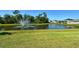 Water view of pond with a fountain and surrounded by green lawn at 364 Grande Vista Blvd, Bradenton, FL 34212