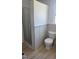 This bathroom features a new toilet, fresh paint, and new laminate flooring at 3730 Ferguson St, Sarasota, FL 34233