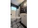 Modern bathroom featuring stylish black and white patterned floor tiles, and contemporary fixtures at 3730 Ferguson St, Sarasota, FL 34233