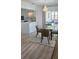 Charming dining area with a round table, stylish lighting, and an open kitchen space at 3730 Ferguson St, Sarasota, FL 34233