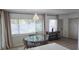 Charming dining area with a round table, stylish lighting, and bright windows overlooking the yard at 3730 Ferguson St, Sarasota, FL 34233