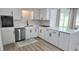 Modern kitchen featuring quartz countertops, sleek cabinetry, stainless steel appliances, and stylish flooring at 3730 Ferguson St, Sarasota, FL 34233