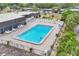 Aerial view of a community pool, tables, and lounge chairs at 3816 Blue Stone Way # 97, Sarasota, FL 34232