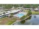 Aerial shot of a community with a pool and a pond near residential buildings and landscaping at 3816 Blue Stone Way # 97, Sarasota, FL 34232